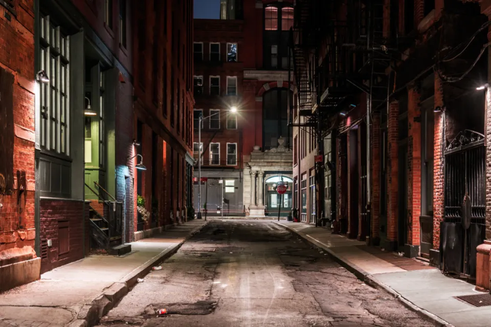 View down New York City alleyway at nighttime